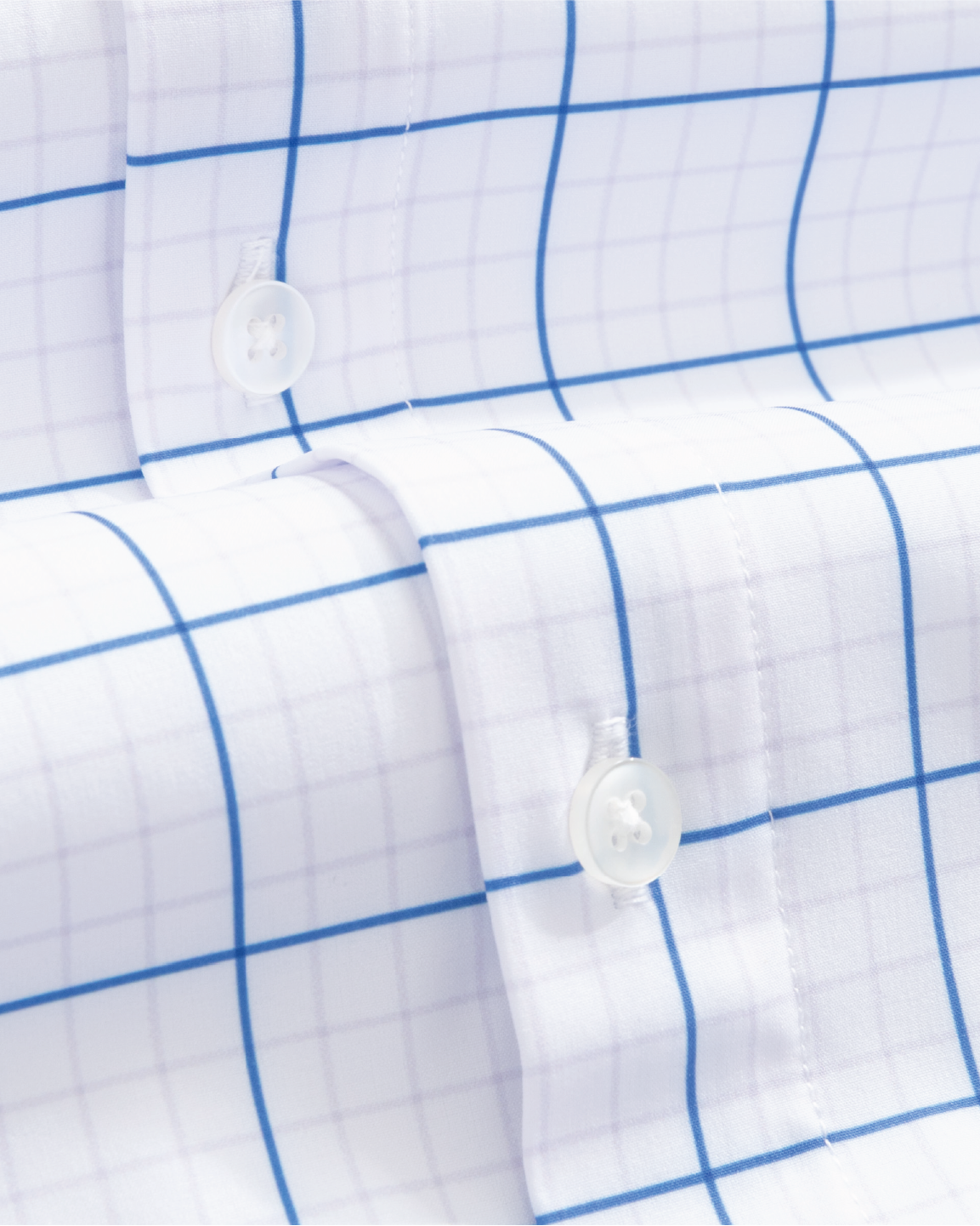 Close-up of a white shirt with navy and grey grids