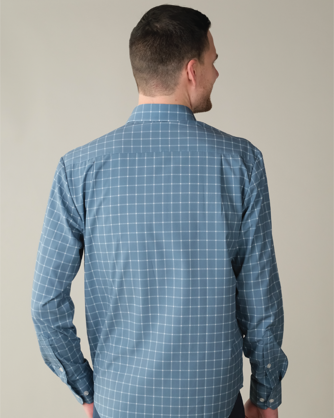 Man wearing ocean blue with white windowpane shirt