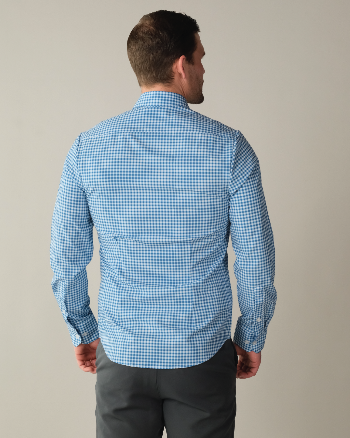Man wearing royal blue and white gingham shirt