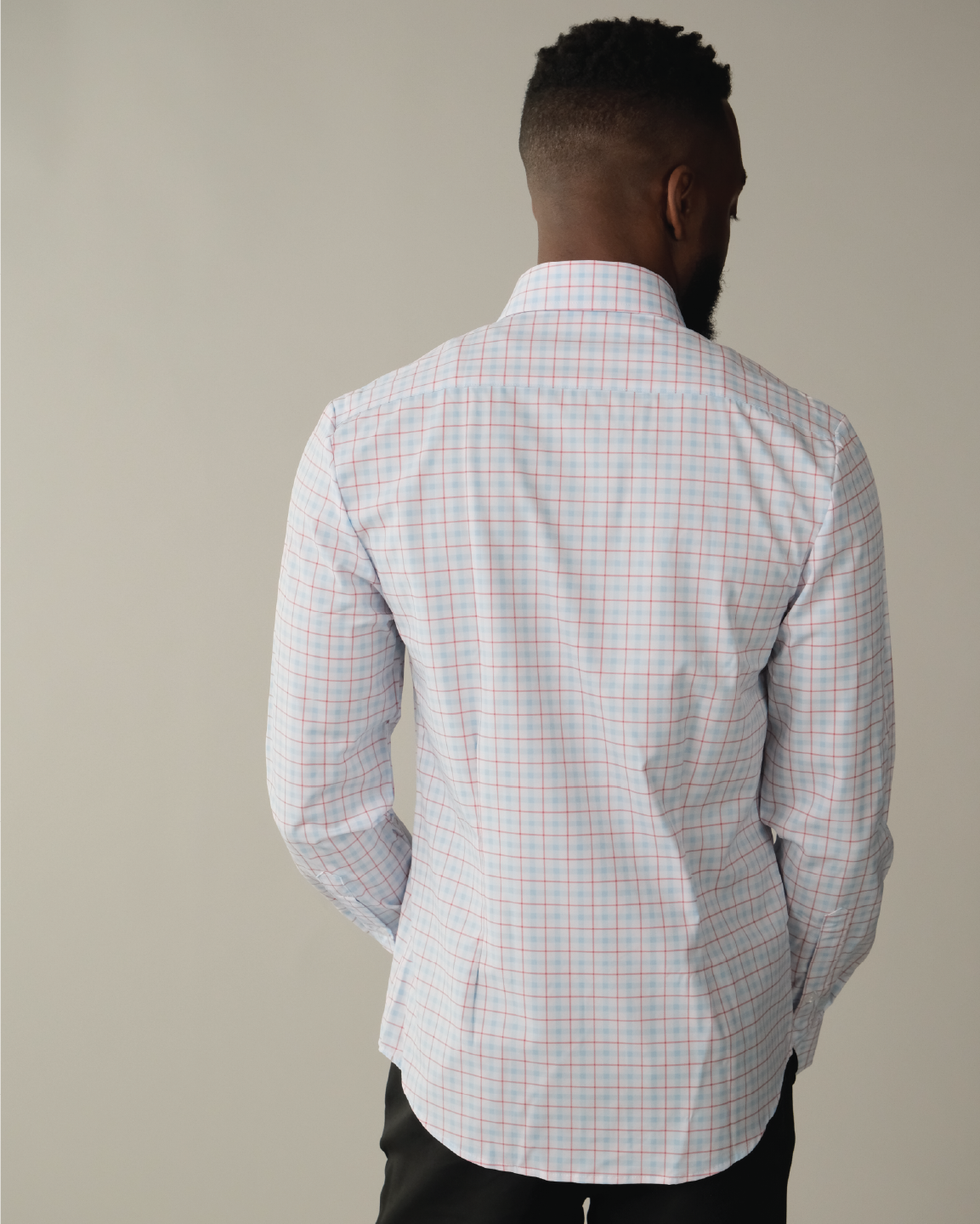 Man wearing white with Red and Blue Windowpane shirt