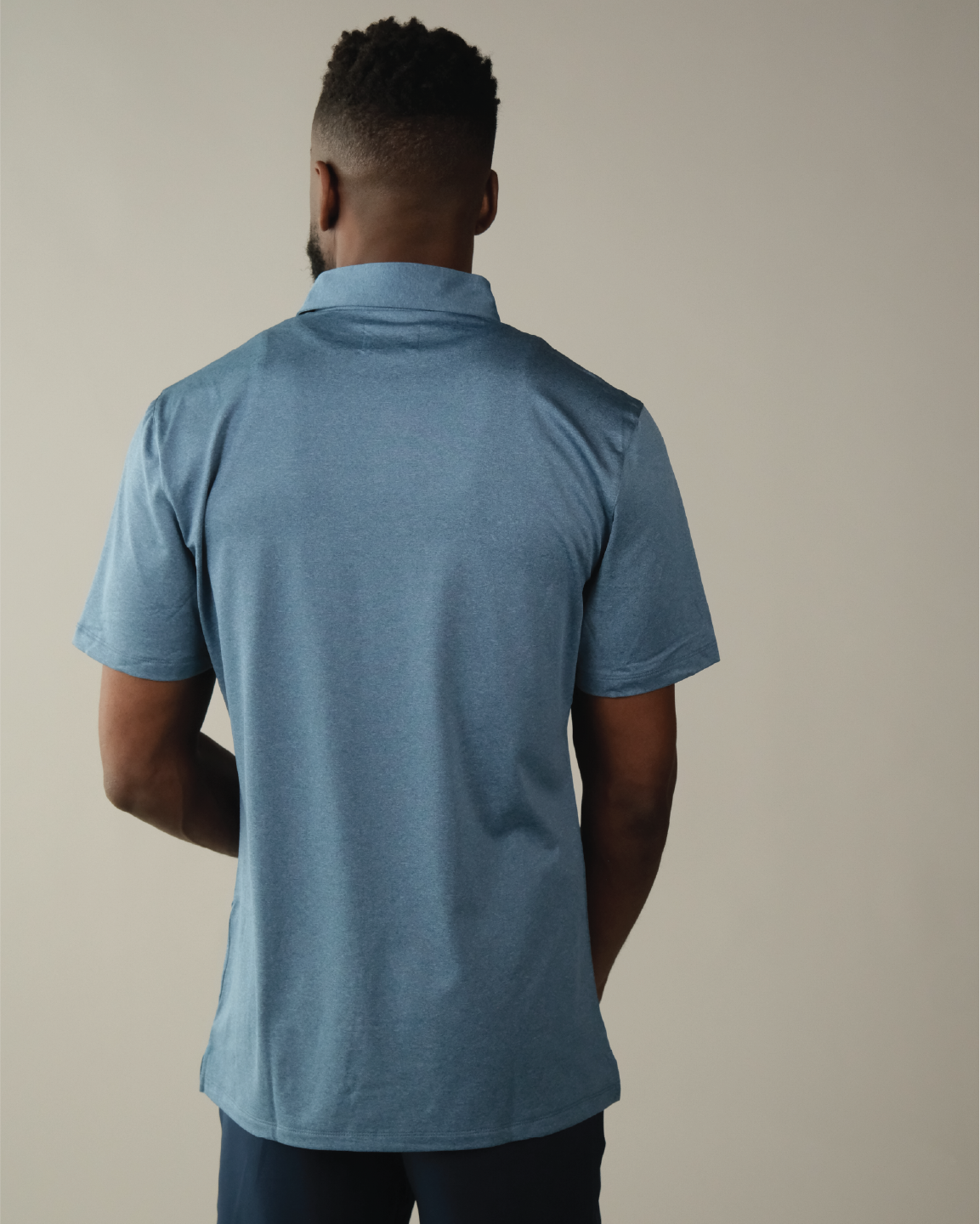 Man wearing a heather blue polo shirt
