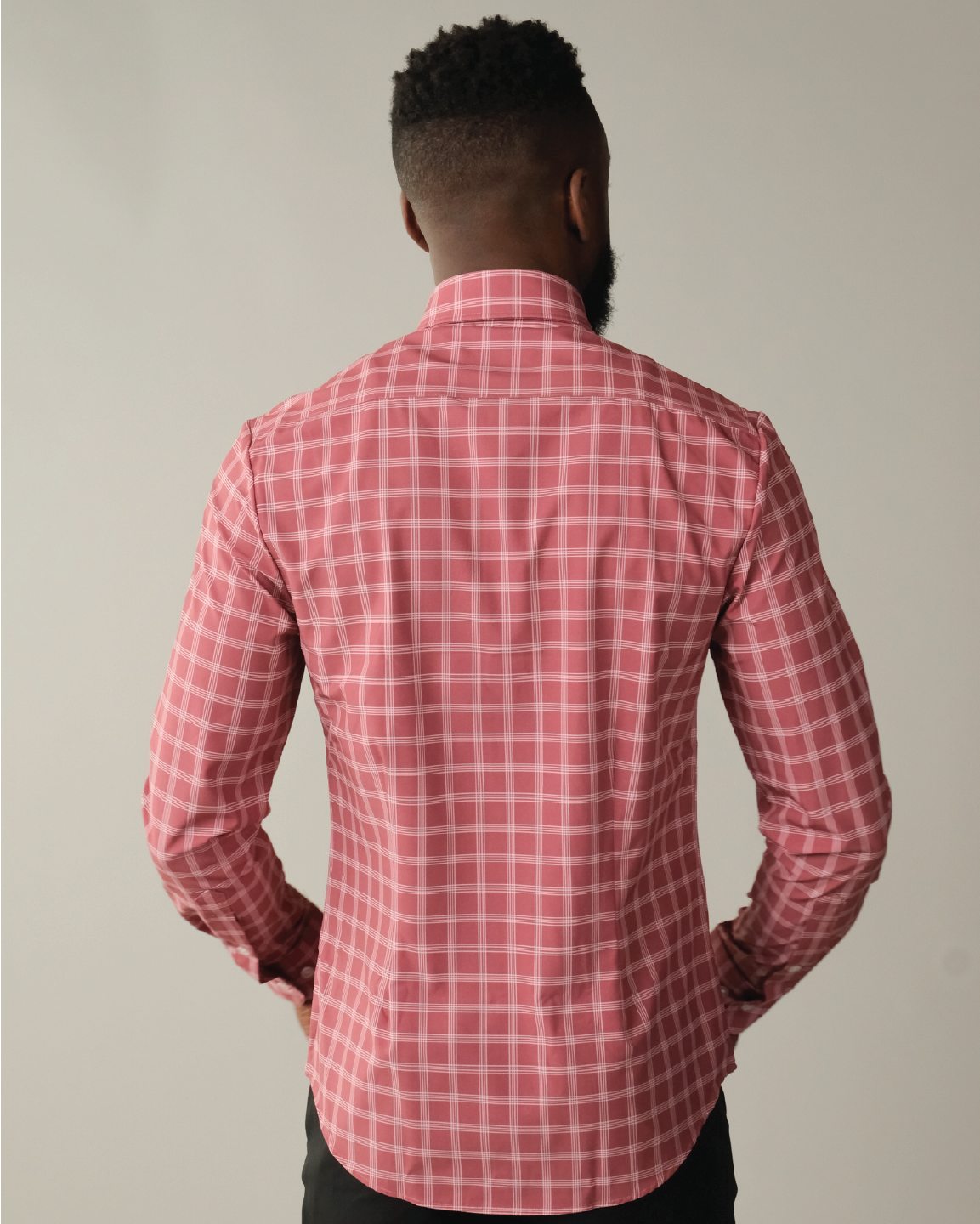 Man wearing adobe red with white windowpane shirt