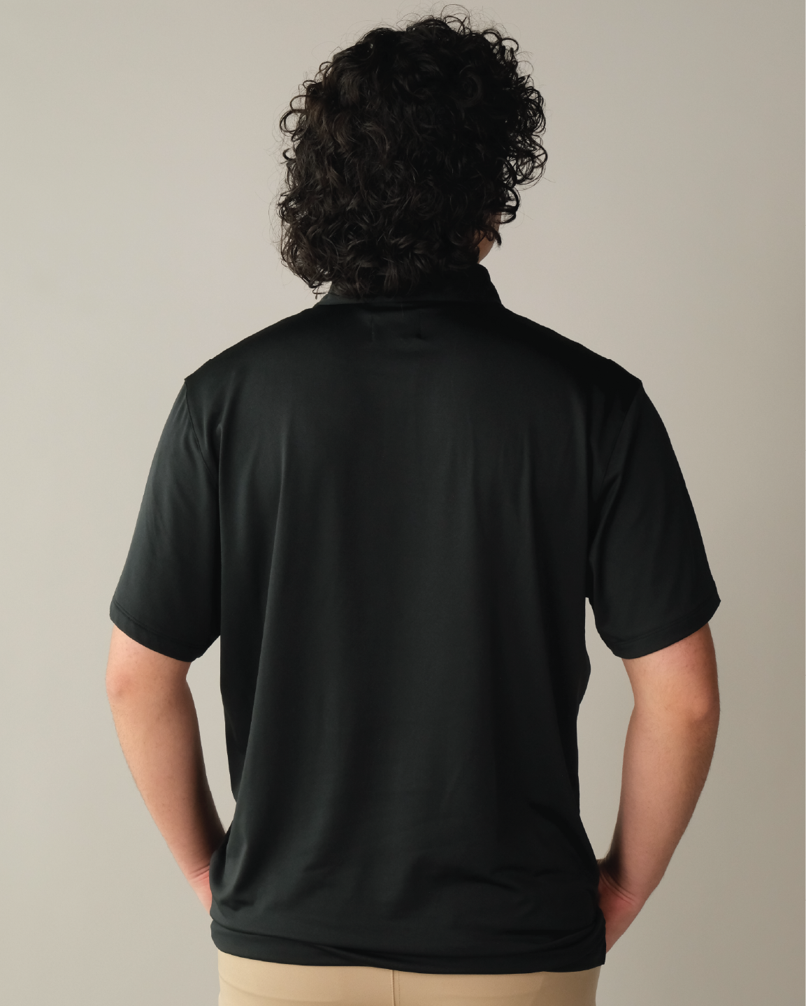 Man wearing pitch black polo shirt