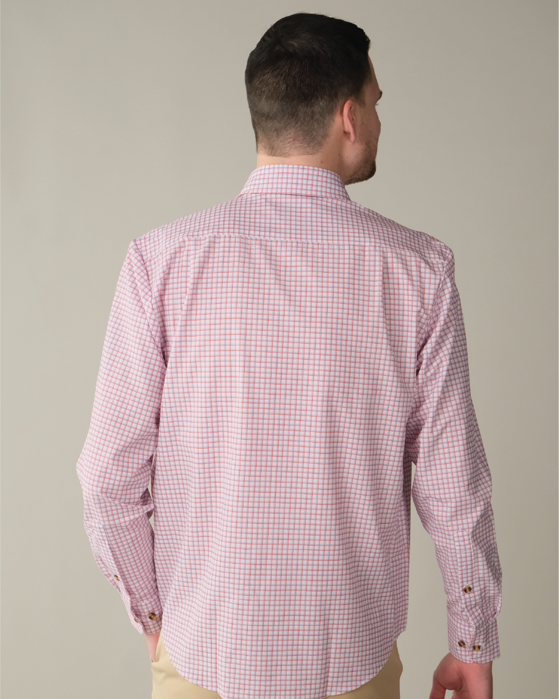 Man wearing white shirt with red and purple windowpane.