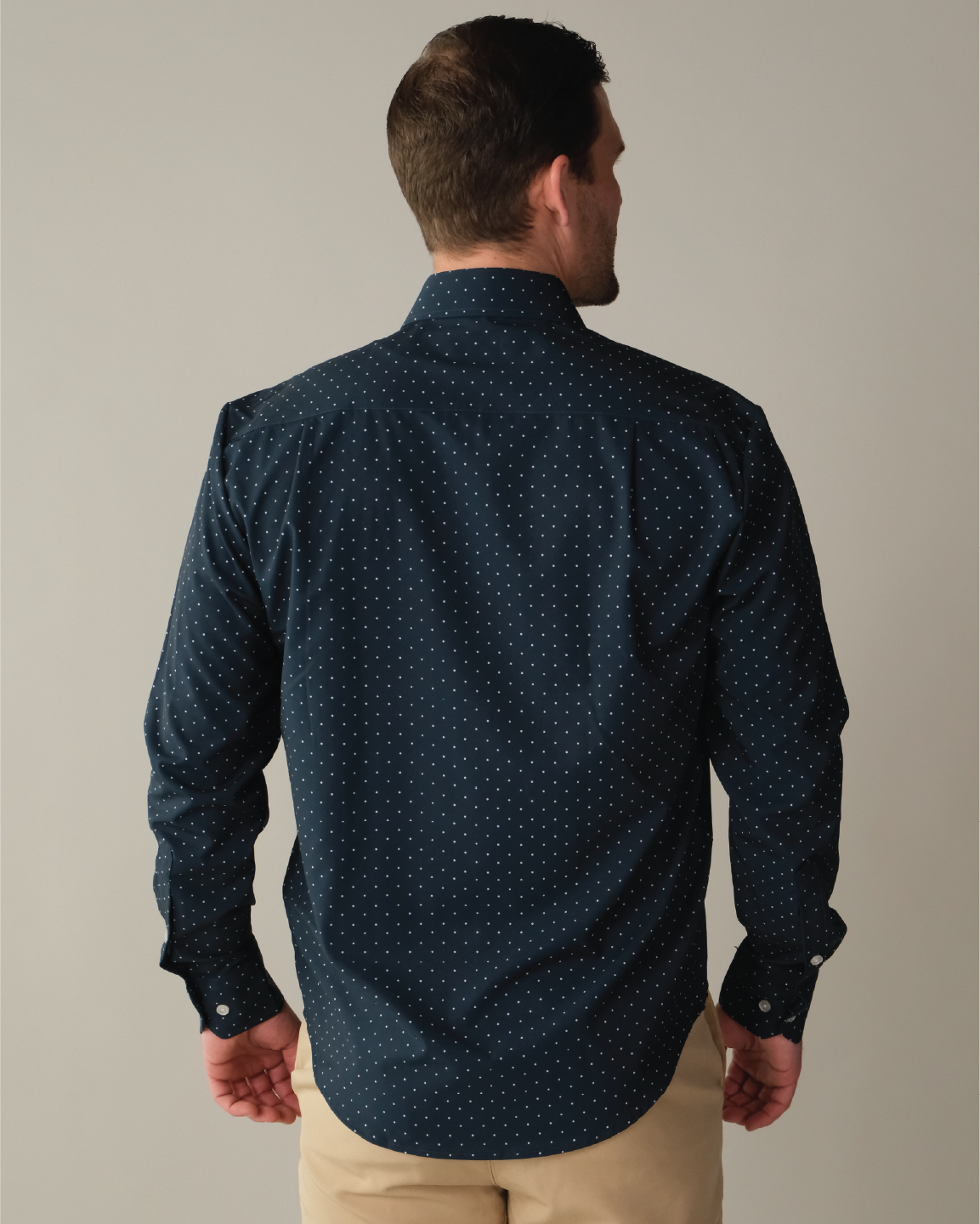 Man wearing navy shirt with white polka dots