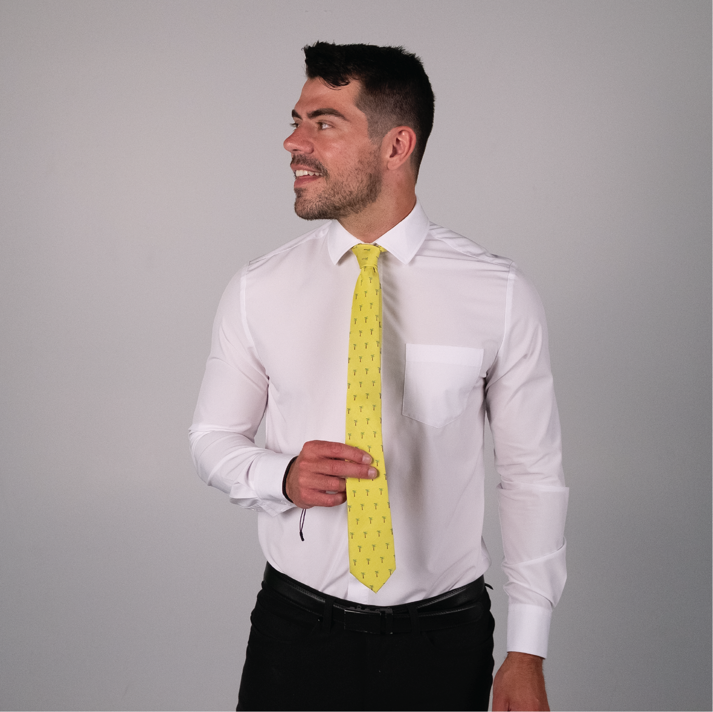Yellow tie with palm tree pattern on a white dress shirt