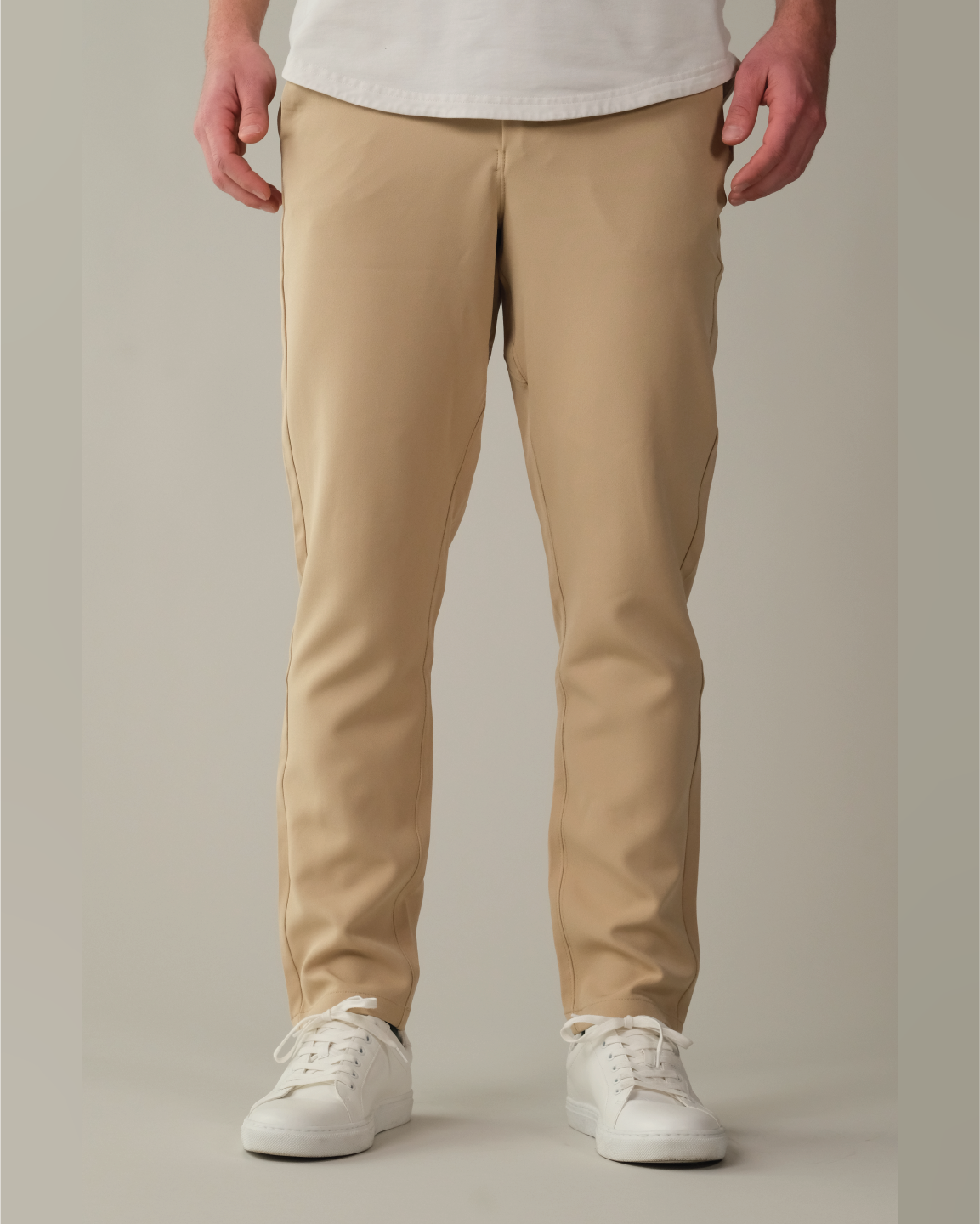Person wearing desert khaki pants and white sneakers