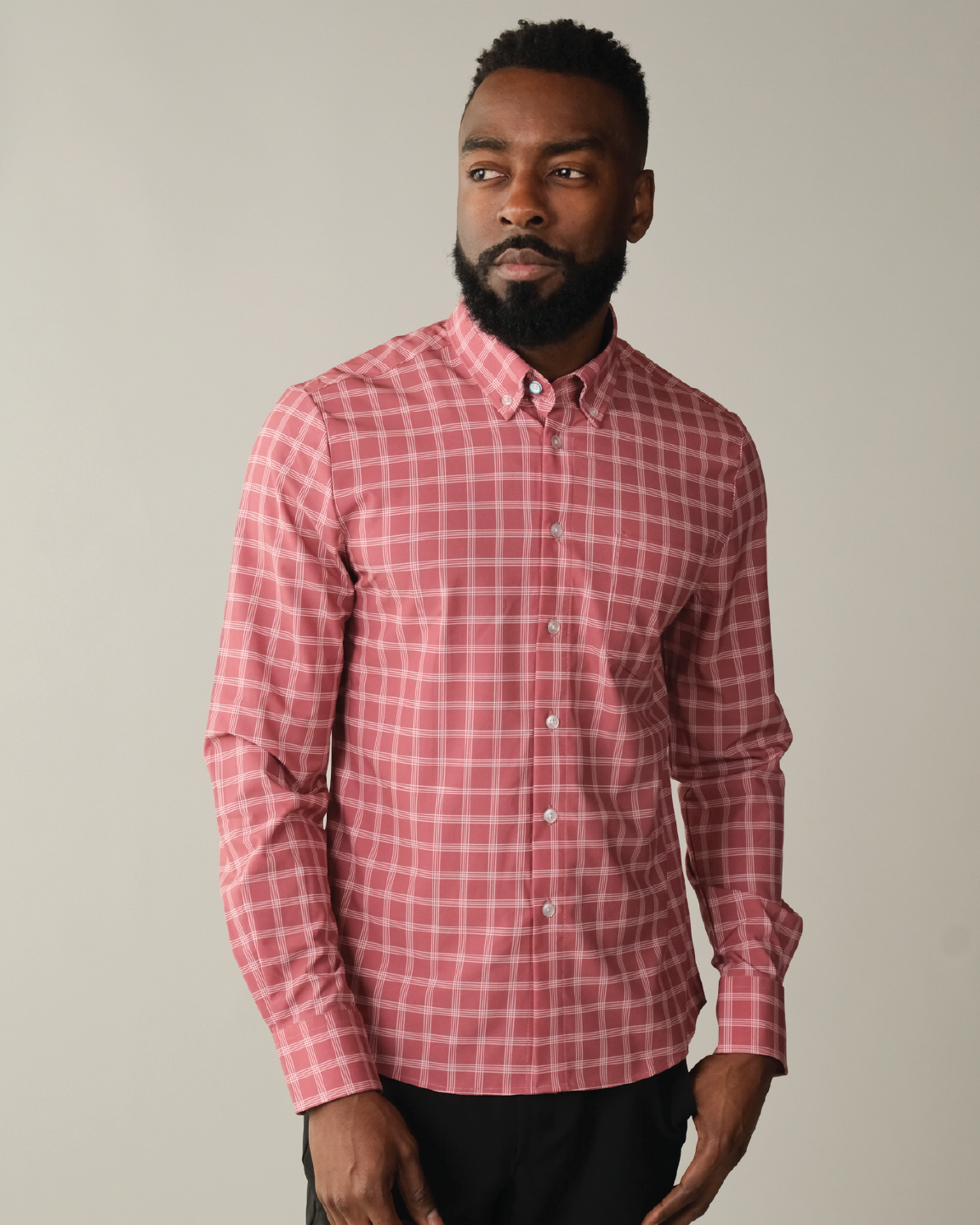 Man wearing adobe red with white windowpane shirt
