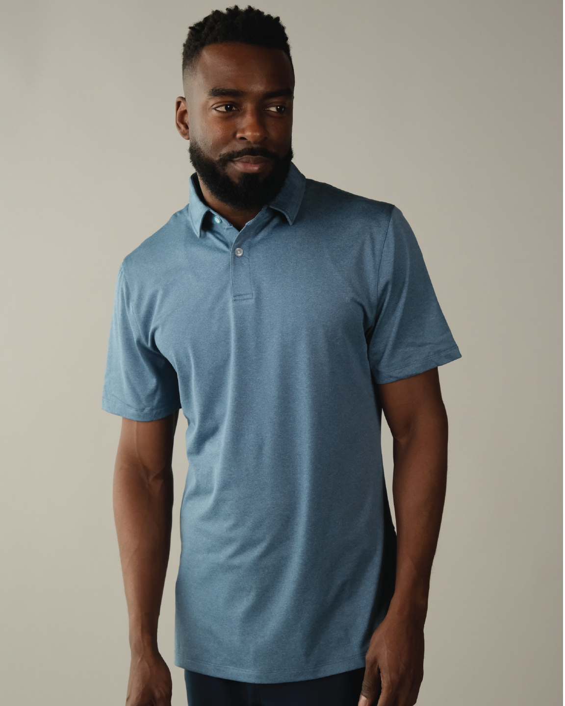 Man wearing a heather blue polo shirt