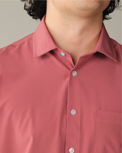 Detail shot of man wearing an adobe red shirt. Top button has blue ring