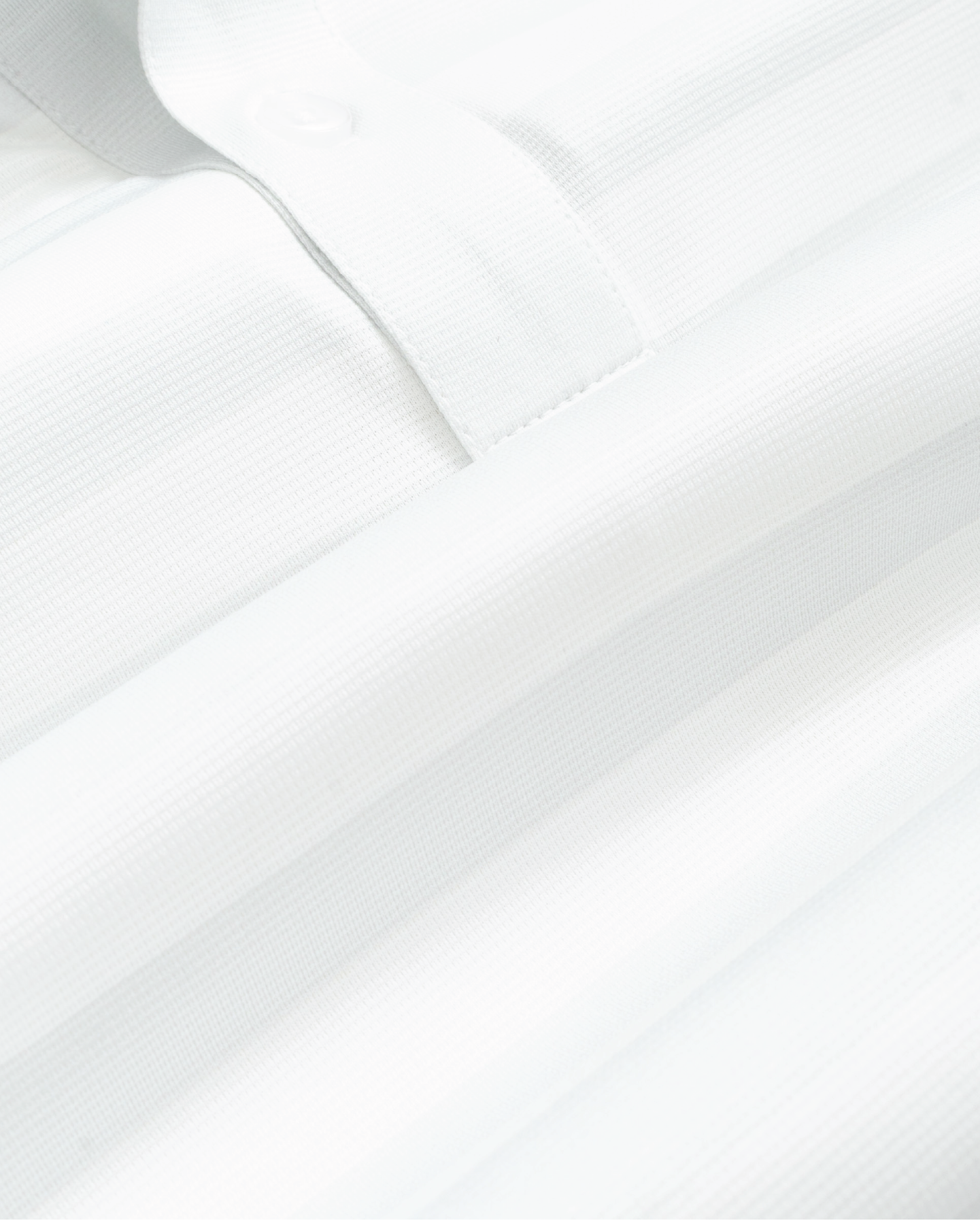 Fabric detail shot of white and gray striped short-sleeve polo shirt, showing texture