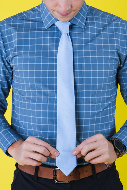 Solid light blue tie on a blue shirt