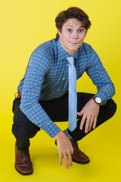 Solid light blue tie on a blue shirt
