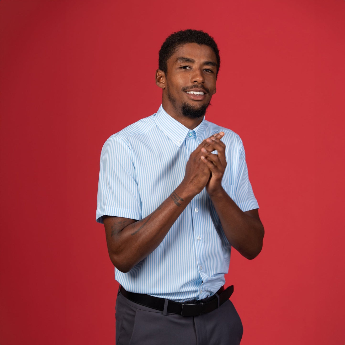 Man wearing White and blue pinstripe shirt