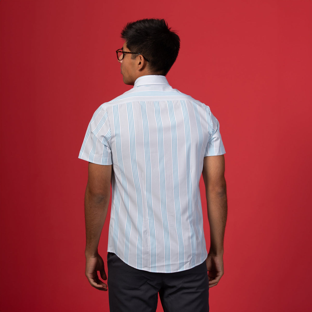 Man wearing Grey shirt with blue and white stripes