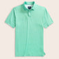 Green and white striped polo shirt on a light pink background