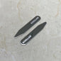 Two metallic collar stays with ' COLLAR' branding on a light marble background