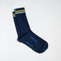 Navy dress socks with light blue &Collar logo, and yellow , green, and white stripes across the top of the sock.