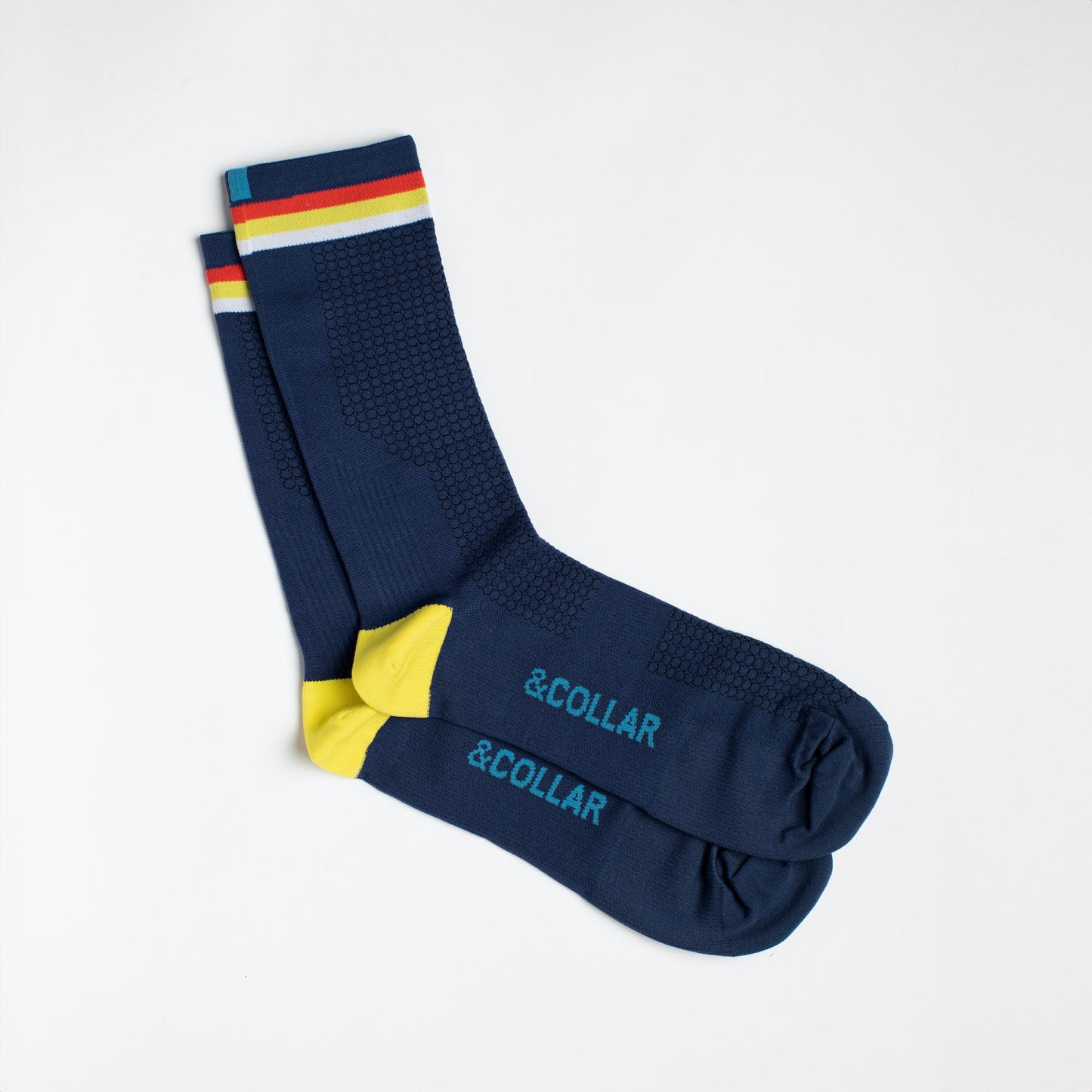 Navy dress socks with light blue &Collar logo, yellow heel, and red, yellow, and white strips across the top of the sock.