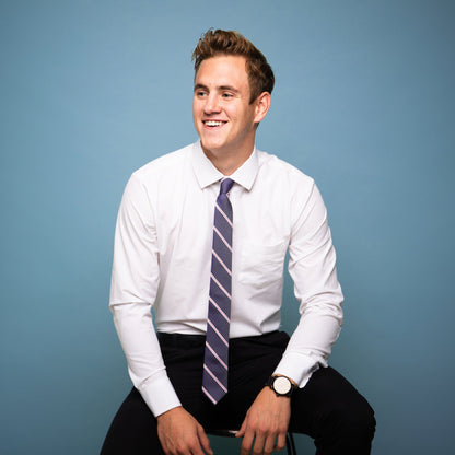 Blue tie with red and white stripes on a white shirt