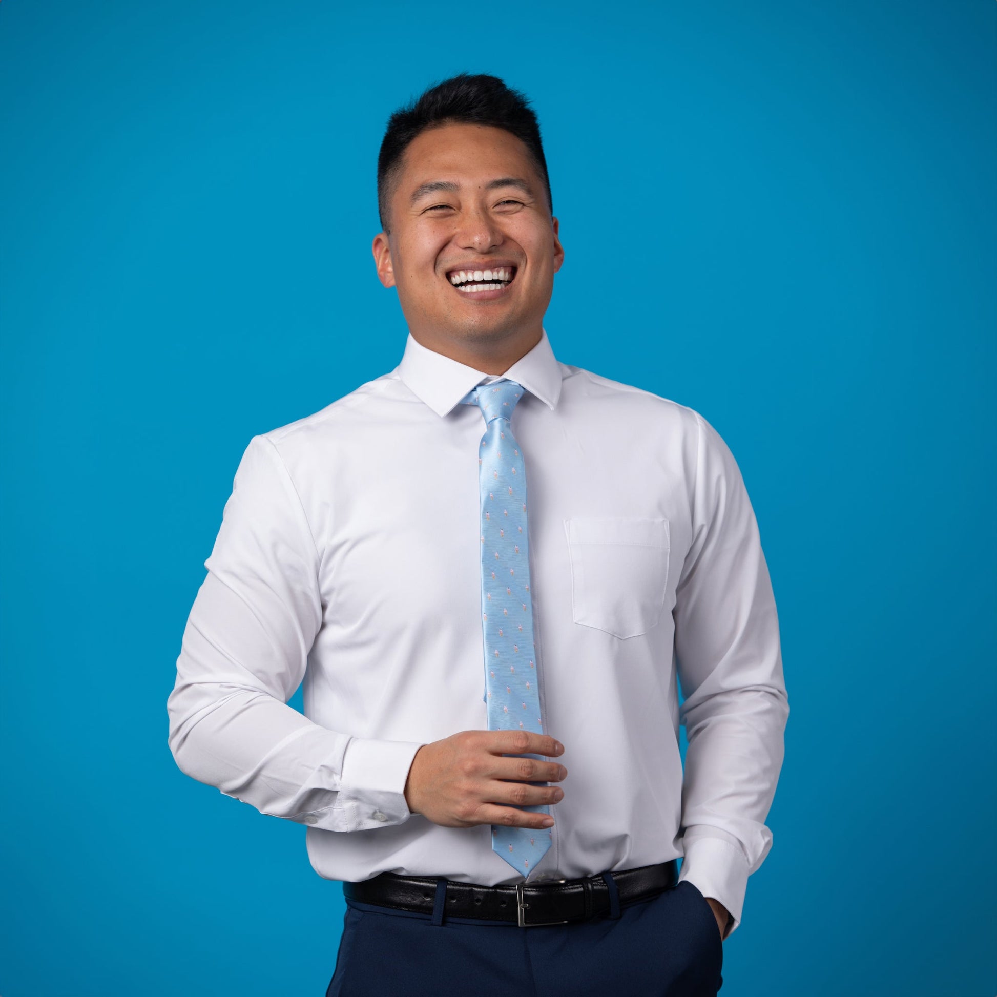 Light blue tie with small ice cream cones on a white shirt