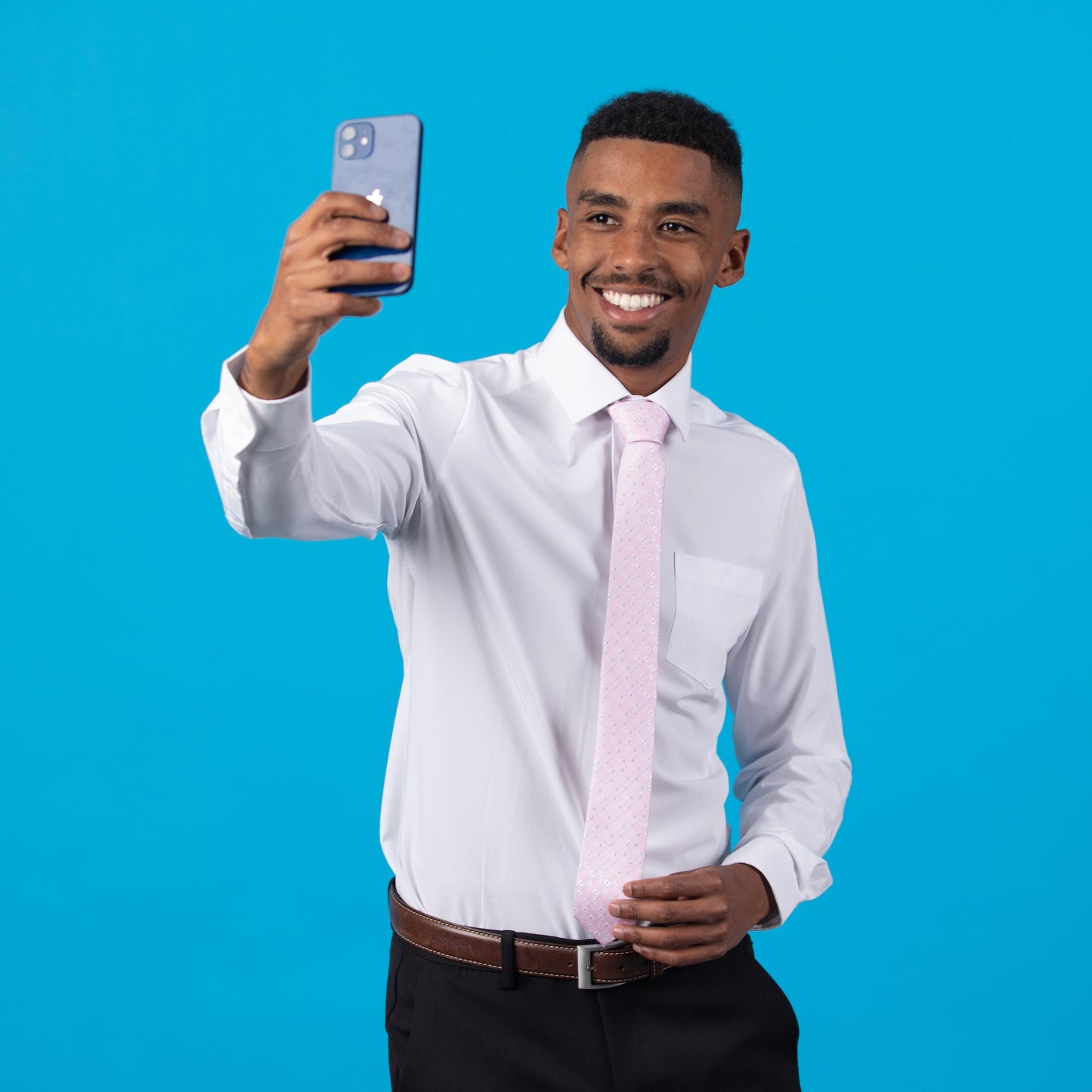 Pink floral patterned tie on a white shirt