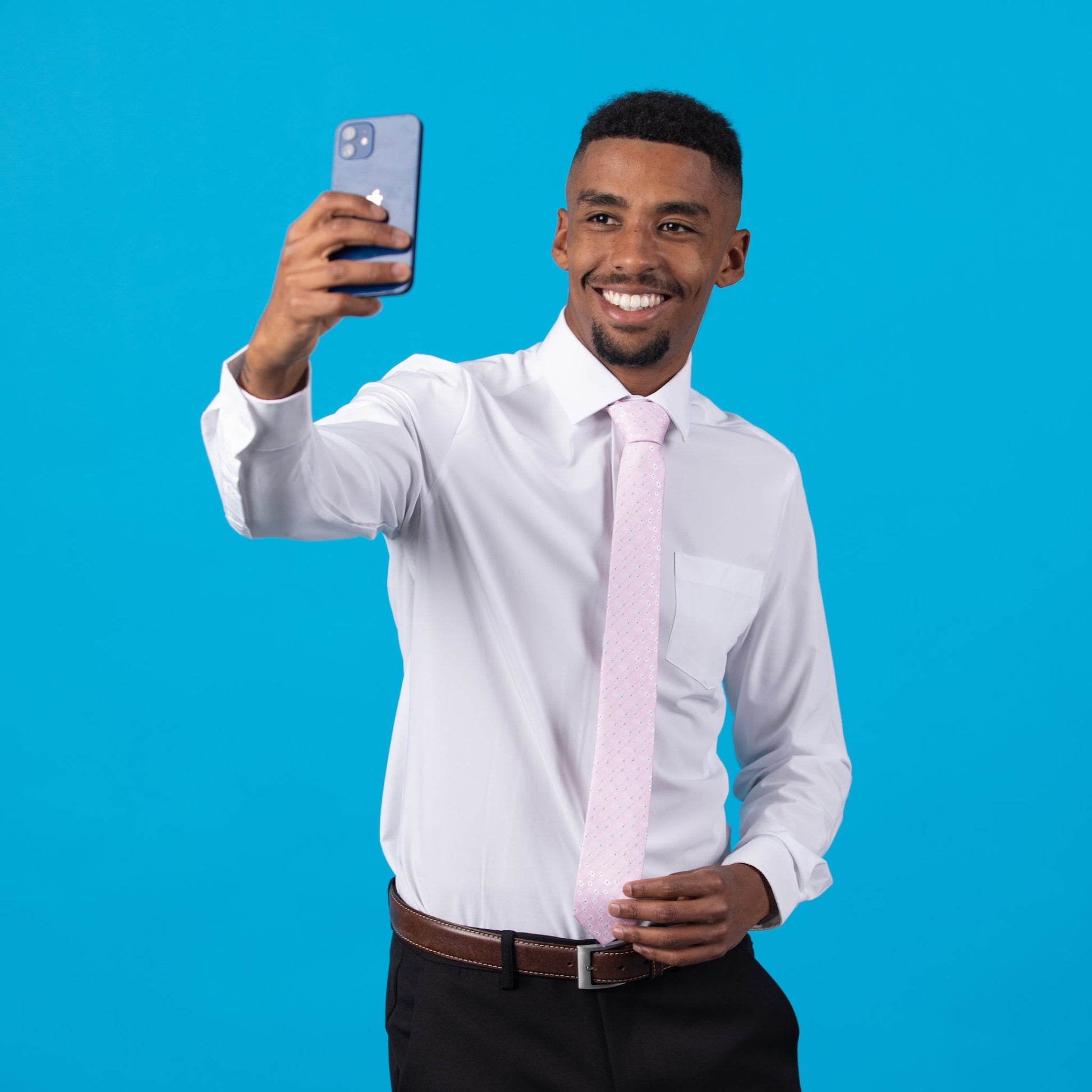 Pink floral patterned tie on a white shirt